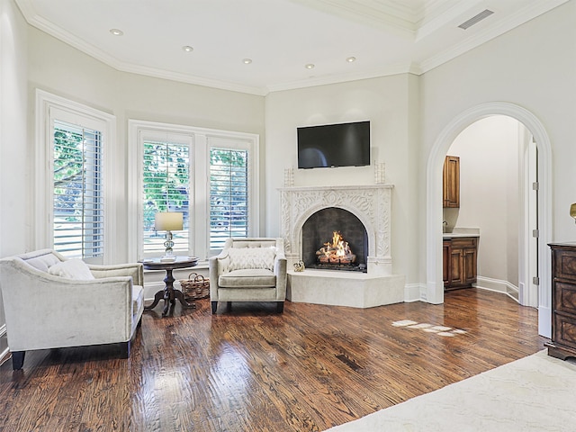 living room featuring a healthy amount of sunlight, a fireplace, and dark hardwood / wood-style flooring