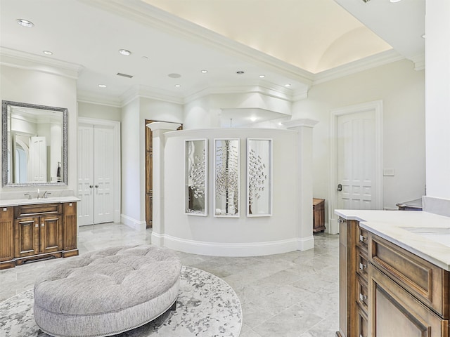 bathroom with vanity, ornate columns, and ornamental molding