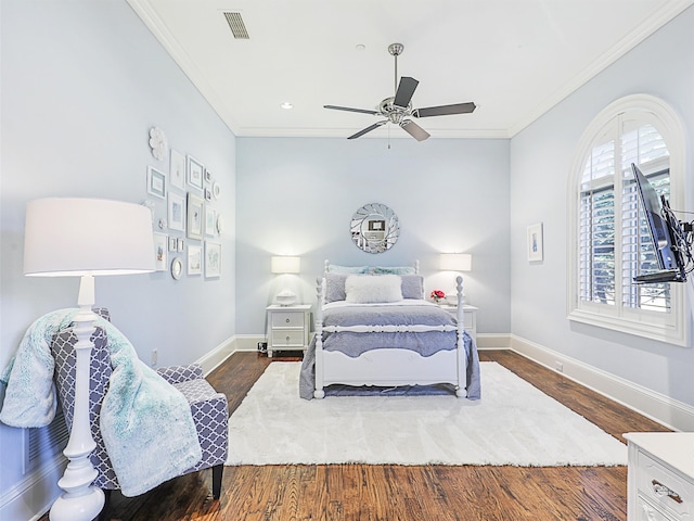 bedroom with dark hardwood / wood-style flooring, crown molding, and ceiling fan