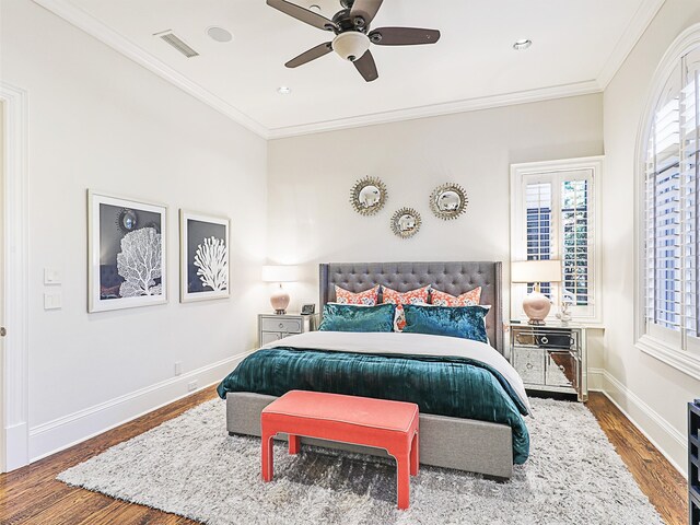 bedroom featuring ceiling fan, hardwood / wood-style flooring, and crown molding