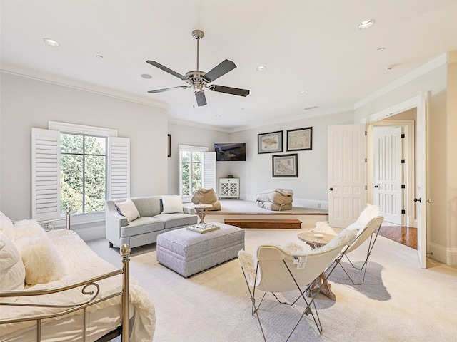 carpeted living room featuring ornamental molding and ceiling fan