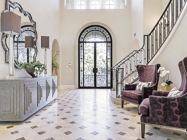 entryway featuring french doors and a high ceiling