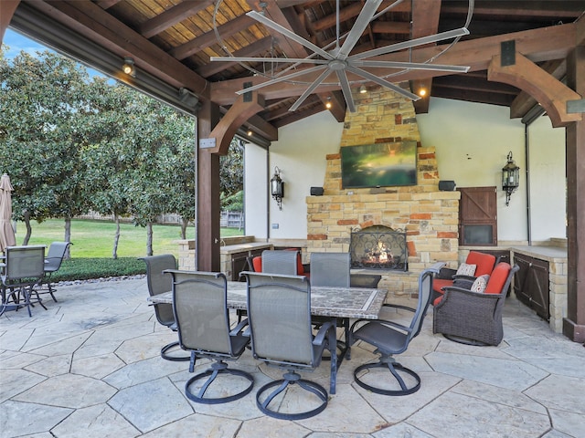 view of patio with a gazebo and an outdoor stone fireplace