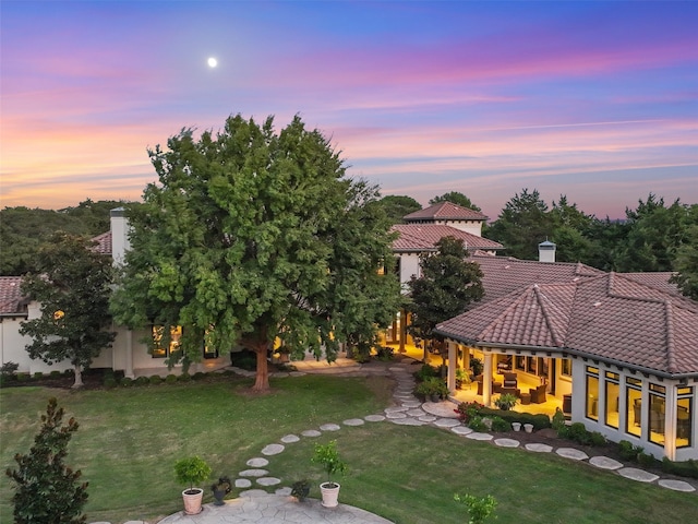 yard at dusk with a patio area