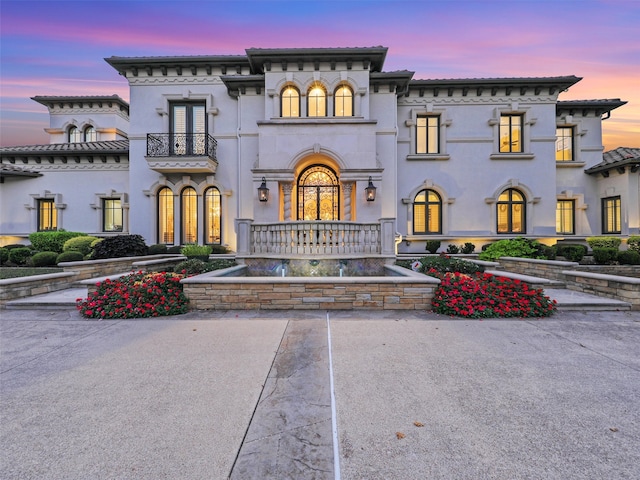 view of front of house with a balcony