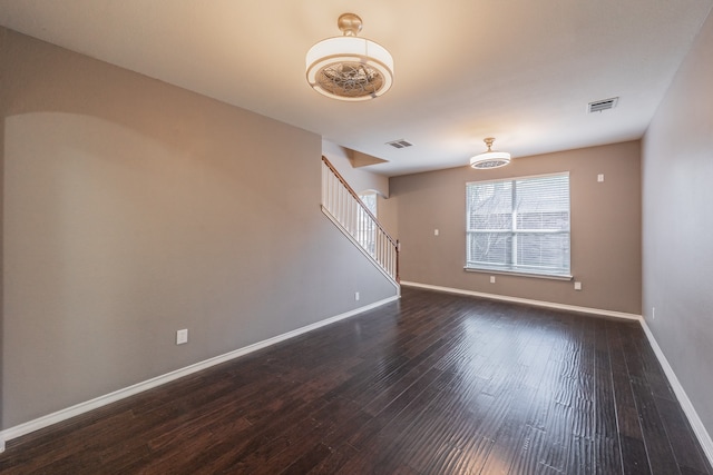 spare room with dark hardwood / wood-style flooring