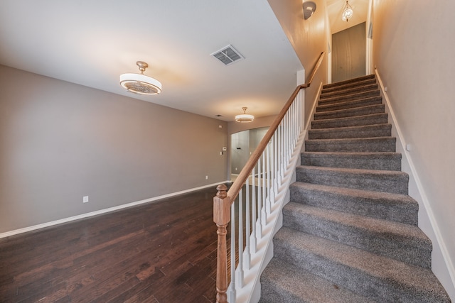 staircase with wood-type flooring