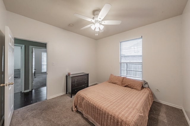 bedroom with ceiling fan and dark carpet