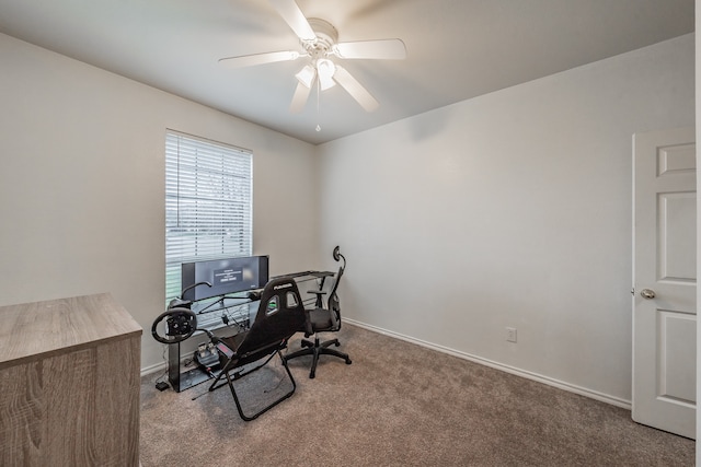 carpeted home office featuring ceiling fan