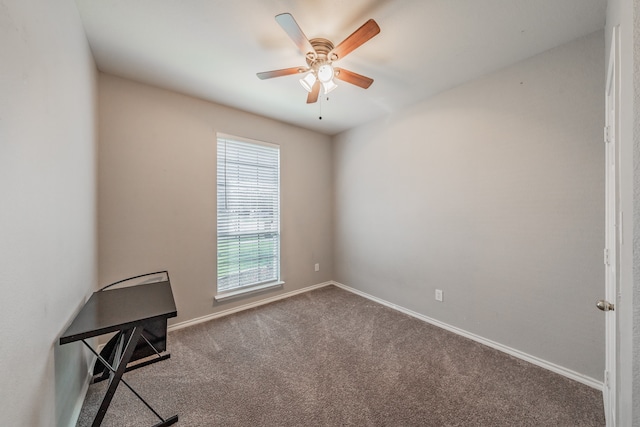 spare room featuring ceiling fan and carpet floors