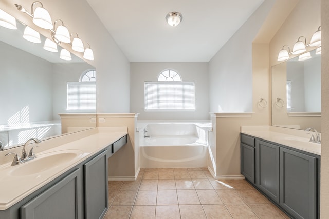 bathroom with vanity, tile patterned flooring, and a bathing tub