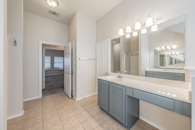 bathroom featuring vanity, vaulted ceiling, tile patterned flooring, and an enclosed shower