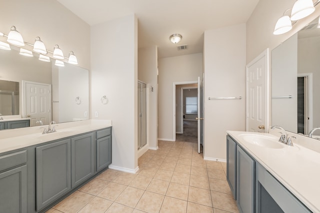 bathroom featuring vanity, an enclosed shower, and tile patterned flooring