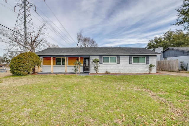 ranch-style home featuring a front yard and covered porch