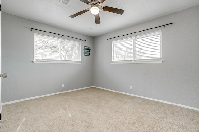 carpeted empty room featuring ceiling fan