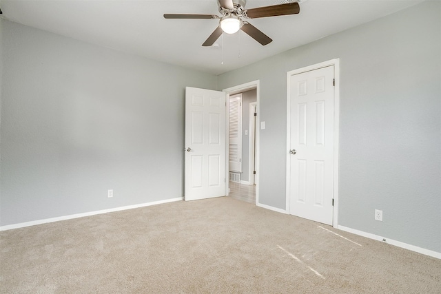 unfurnished bedroom featuring ceiling fan and carpet