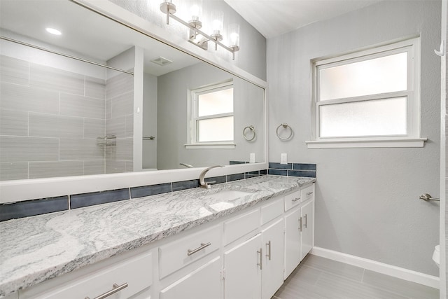 bathroom featuring vanity and a shower