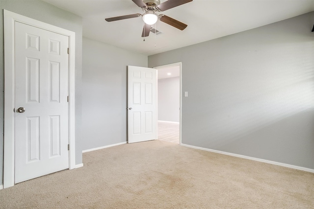 unfurnished bedroom featuring light carpet and ceiling fan