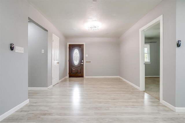 entryway featuring a textured ceiling and light wood-type flooring