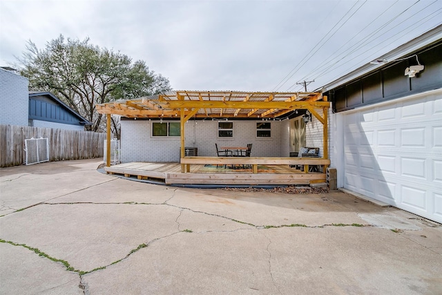 rear view of property featuring a pergola and a deck