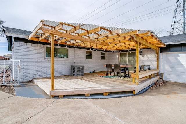 wooden terrace with central AC, a garage, and a pergola