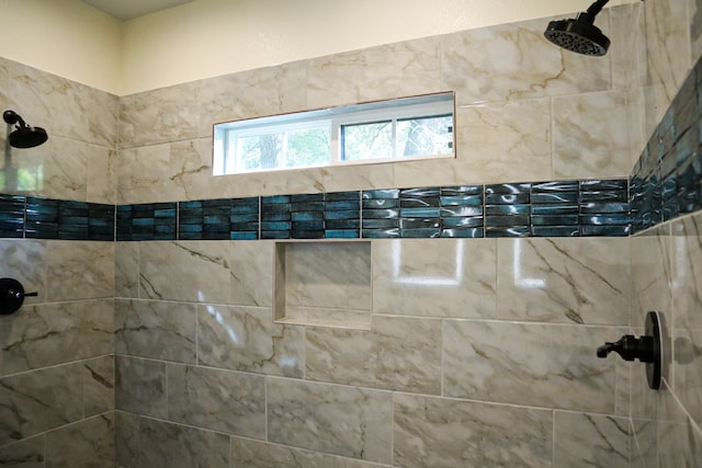 bathroom with a tile shower