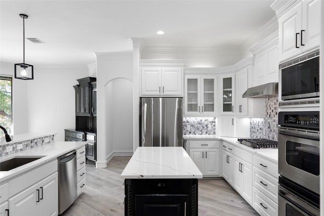 kitchen featuring decorative backsplash, a center island, stainless steel appliances, and white cabinets