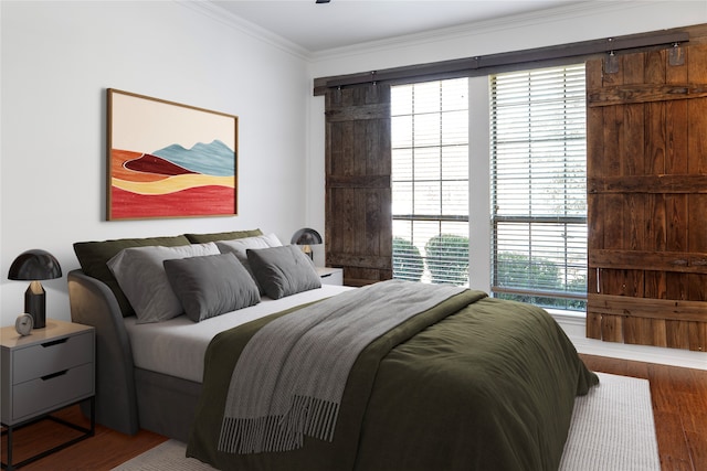 bedroom featuring hardwood / wood-style floors and crown molding