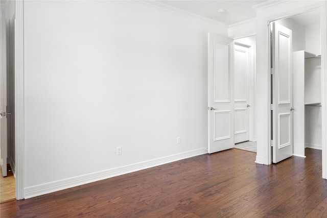 unfurnished bedroom featuring crown molding and dark hardwood / wood-style floors