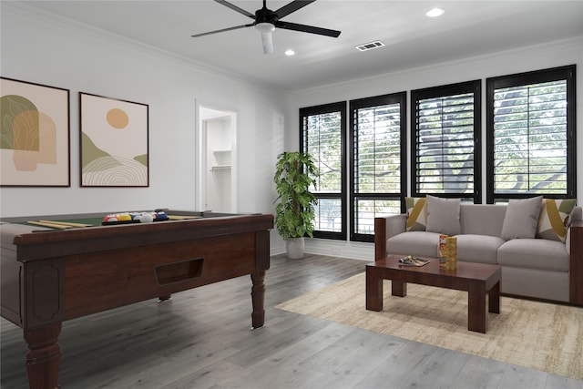 recreation room with ceiling fan, light hardwood / wood-style floors, and ornamental molding