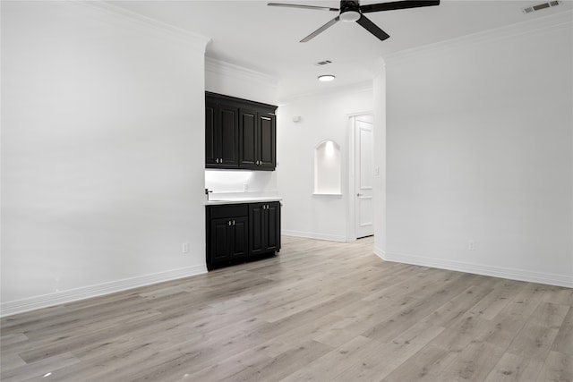 unfurnished living room with light wood-type flooring, ceiling fan, crown molding, and sink