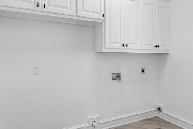 clothes washing area featuring cabinets, washer hookup, light wood-type flooring, and hookup for an electric dryer