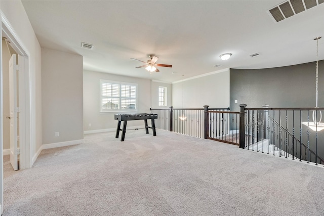 carpeted empty room with a ceiling fan, visible vents, and baseboards