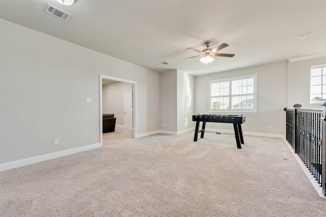 rec room featuring plenty of natural light, ceiling fan, and light carpet