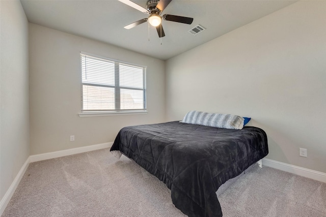 bedroom featuring light carpet, visible vents, and baseboards