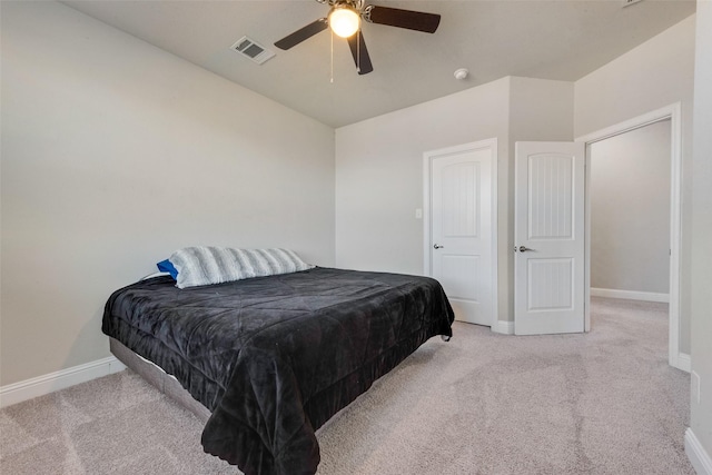 bedroom featuring baseboards, a ceiling fan, visible vents, and light colored carpet