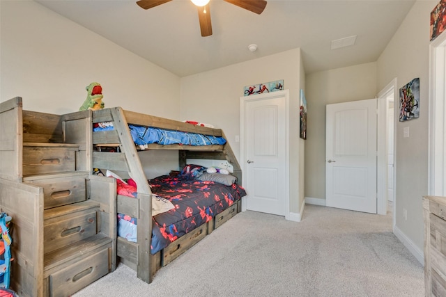 bedroom with light carpet, ceiling fan, and baseboards