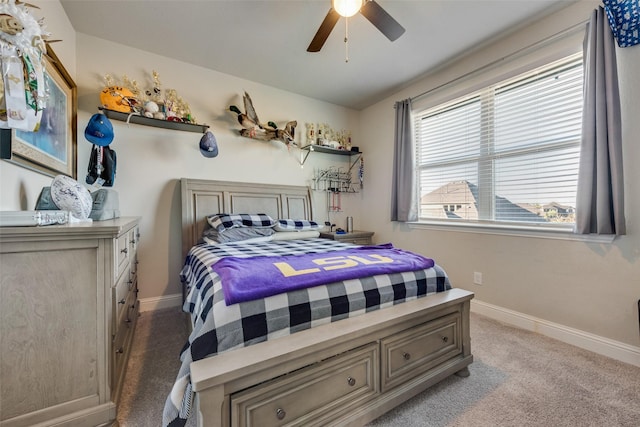 bedroom with light carpet, a ceiling fan, and baseboards