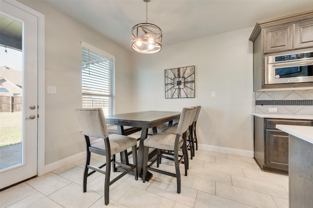 dining area with baseboards and light tile patterned floors