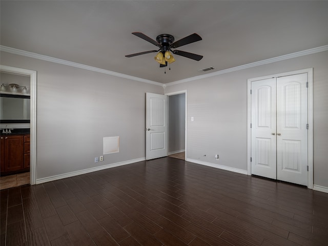 unfurnished bedroom featuring ornamental molding, dark hardwood / wood-style floors, a closet, and ceiling fan