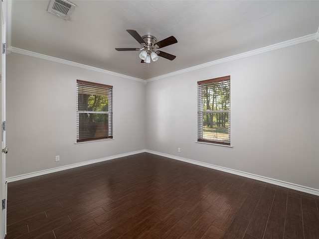 spare room with dark wood-type flooring, crown molding, a healthy amount of sunlight, and ceiling fan