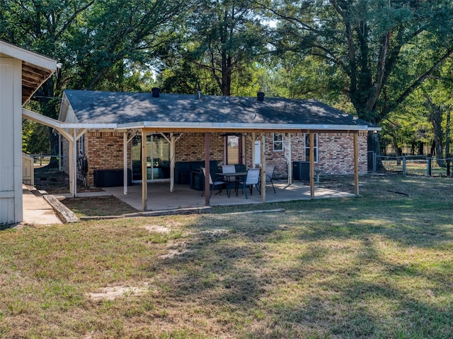 rear view of property with a patio area and a lawn