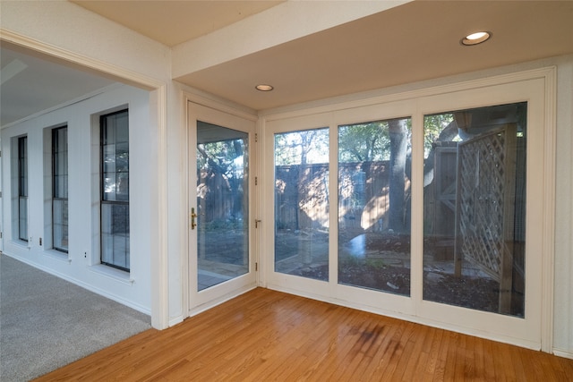 unfurnished sunroom featuring a wealth of natural light