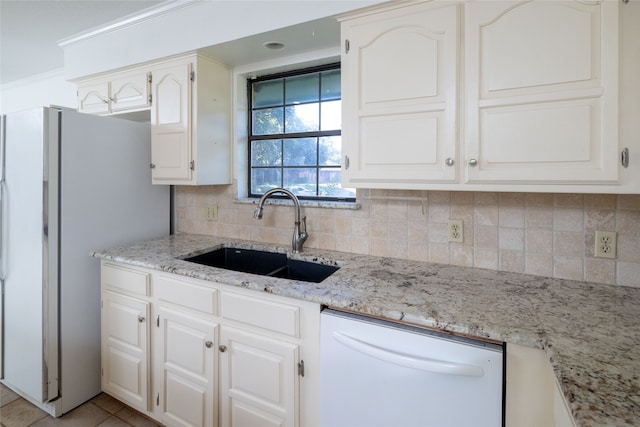 kitchen featuring white appliances, white cabinetry, and sink