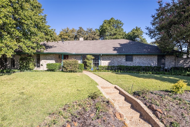 single story home featuring a front lawn