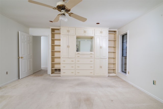 unfurnished bedroom with ceiling fan, light carpet, and multiple windows