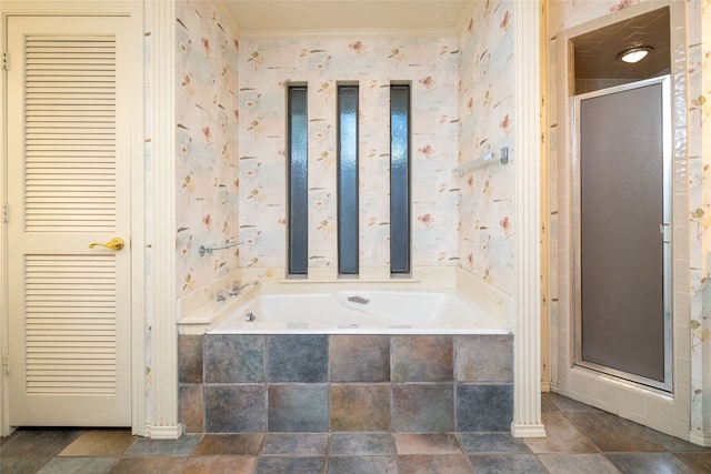 bathroom with ornamental molding and plus walk in shower