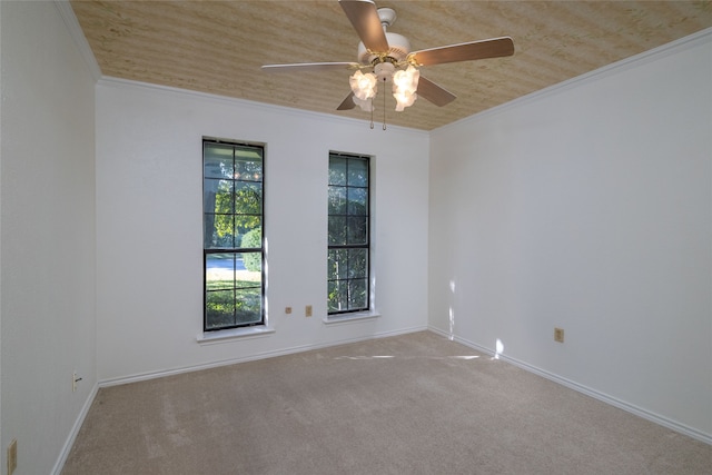 carpeted spare room featuring crown molding, wooden ceiling, and ceiling fan