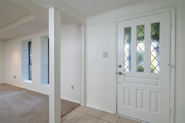 carpeted entrance foyer with ornamental molding