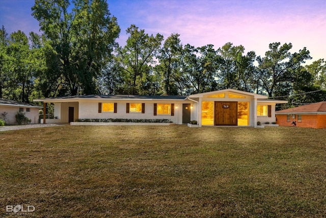 ranch-style house featuring a yard